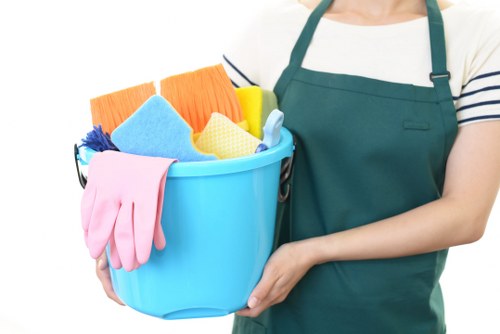 Professional office cleaner working in a busy E1 workplace reception area