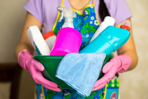 Cleaning team maintaining desks and shared office surfaces in an E1 business